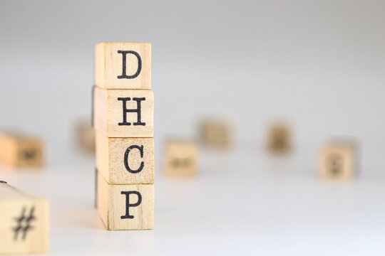 Dynamic Host Configuration Protocol acronym. word dhcp written on wooden cubes isolated on white background with copy space. Concept of concept of network conceptions, ip addressing