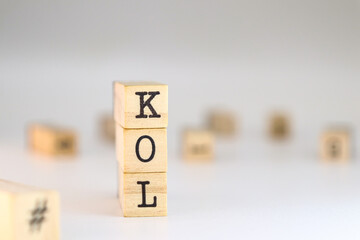 Key Opinion Leader acronym. word KOL written on wooden cubes isolated on white background with copy space. Concept of concept of digital expert, influencer