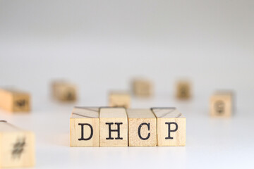 Dynamic Host Configuration Protocol acronym. word dhcp written on wooden cubes isolated on white background with copy space. Concept of concept of network conceptions, ip addressing