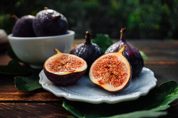 Delicate Fresh Ripe Figs With Leaves On White Plate, Rustic Wooden Table. Ficus