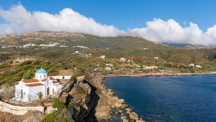 Fototapeta premium Scenic coastal view capturing a peninsula with rocky shores and serene blue waters under a partly cloudy sky - Ammitsa beach, Neapoli Lakonia
