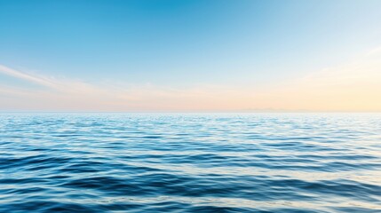 Obraz premium A serene ocean scene with a clear blue sky and gentle waves.