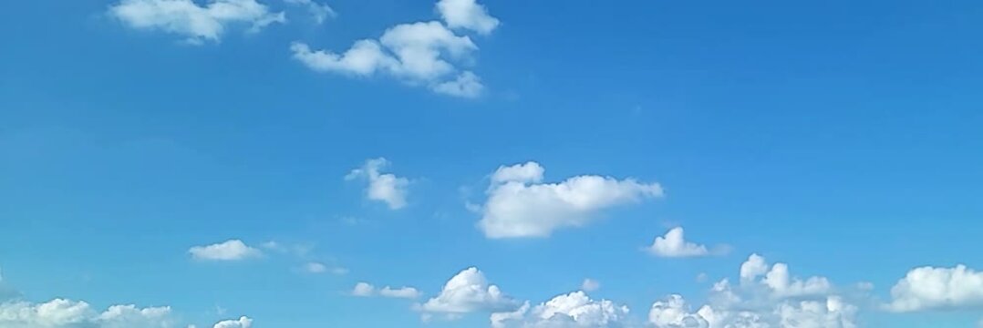 Cloudscape, Timelapse of a beautiful blue sky with fluffy white clouds, for a wide background	

