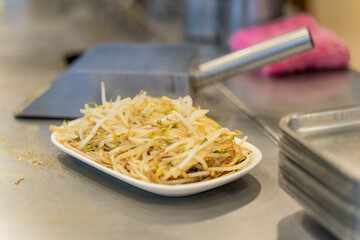 A sizzling plate of bean sprout teppanyaki captures the essence of Japanese-style street food—simple, aromatic, and full of texture. Lightly stir-fried on a hot iron griddle, the bean sprouts
