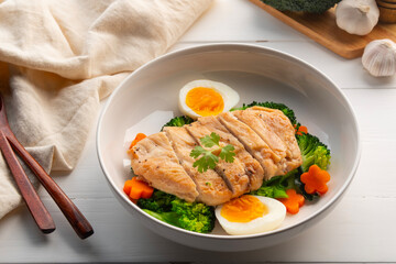 Healthy Diet High Protein Low Fat,Grilled Chicken breast with boiled egg and broccoli in white plate.weight loss menu.