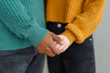 Interracial Couple Holding Hands in Cozy Sweaters