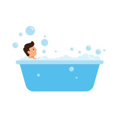 Boy enjoying a bubble bath in a blue tub filled with bubbles