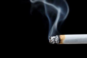 Cigarette producing swirling smoke in a chaotic moment of solitude