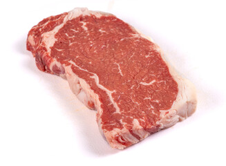 A well marbled New York strip loin beef steak isolated on white