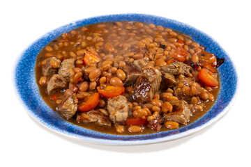 Cowboy steak and beans, a plate of baked beans with chunks of beef steak isolated on white