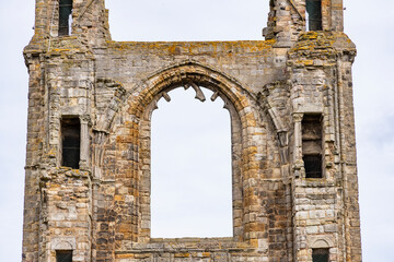 The ruins of St Andrews Cathedral overlook the sea, surrounded by ancient tombs and old stone...