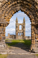 Fototapeta premium The ruins of St Andrews Cathedral overlook the sea, surrounded by ancient tombs and old stone walls. A peaceful, sacred place filled with religious history and timeless beauty. Endless architecture.