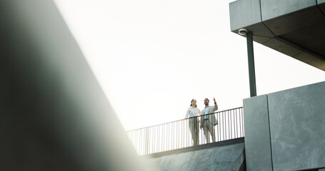 Building, rooftop and teamwork with business people outdoor for meeting or planning. City, pointing...
