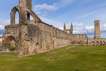 Fototapeta premium The ruins of St Andrews Cathedral overlook the sea, surrounded by ancient tombs and old stone walls. A peaceful, sacred place filled with religious history and timeless beauty. Endless architecture.