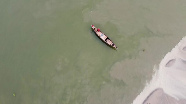 Drone shot of river bank and boat in Jamuna River Bangladesh