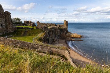 The ruins of St Andrews Cathedral overlook the sea, surrounded by ancient tombs and old stone...