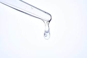 Pipette with delicate blue serum close-up.