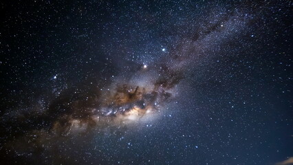 Fototapeta premium A breathtaking starry sky, with countless twinkling stars scattered across the dark canvas of the night, possibly with a faint glow of the Milky Way.