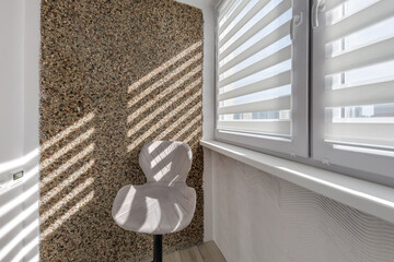 Modern double roller zebra blinds on large windows in bright minimalist interior with sunlight streaming through on balcony © hiv360