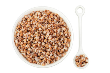 Boiled buckwheat in a ceramic bowl isolated on white background. Top view. Flat lay