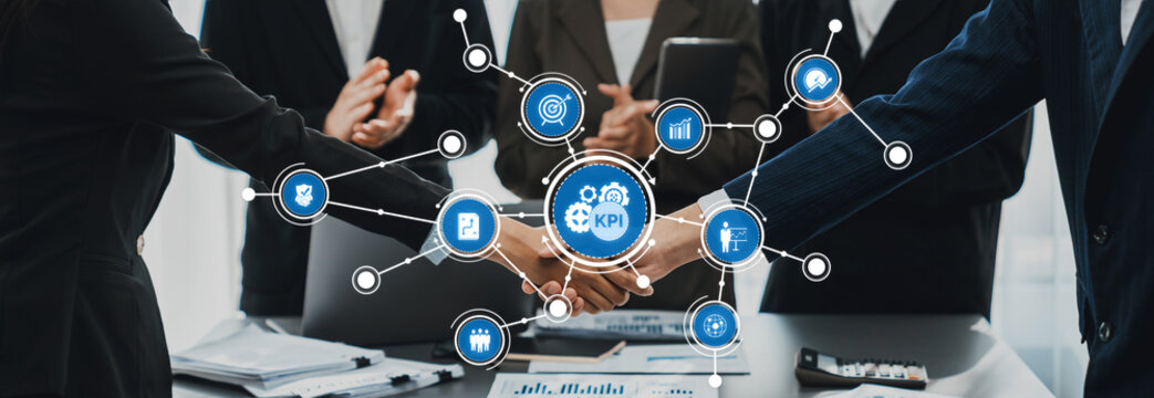 A professional meeting highlights collaboration with KPI metrics displayed on a digital interface, showcasing teamwork and strategic planning for business growth. Amity - Powered by Adobe