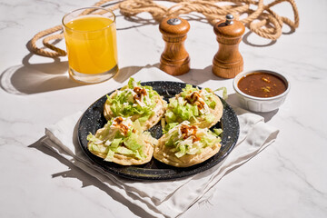 Traditional mexican food sopes, made with corn, beans, salsa and cheese