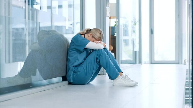 Woman, healthcare and sad nurse in hospital with regret, doubt and overwhelmed in career. Tired, stress and medical professional with depression in lobby for treatment fail, bad news and patient loss