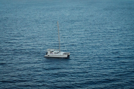 Lonely Sailboat On Serene Ocean Waters