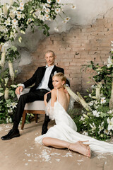 Attractive young couple in love in wedding dresses spending time together