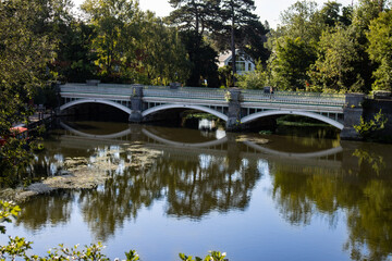 Reflection of the Old Wey Bridge crossing, between Addlestone and Weybridge, over the River Wey Navigations in Surrey