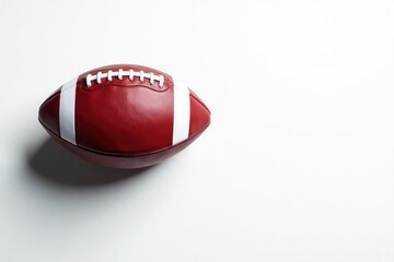 Overhead view of an American football against a stark white backdrop , sport, photography