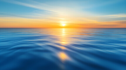 Golden sunrise reflecting on calm ocean waters