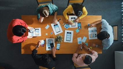 Creative team putting hand together while brainstorm about Ux Ui design mobile phone interface....