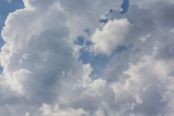 Fluffy white clouds on a blue sky background