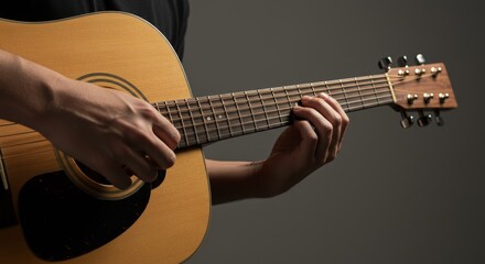 Fototapeta premium Acoustic Guitar Close Up Hands - Close up of hands strumming an acoustic guitar. Symbolizing music, passion, skill, creativity, and artistry