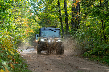 ATV, riding on trail through wooded scenery, north woods all terrain vehicle, UTV © Amanda