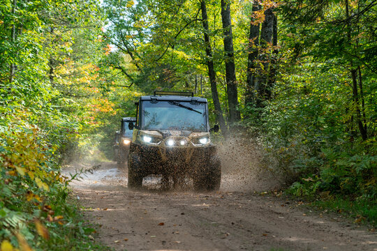ATV, riding on trail through wooded scenery, north woods all terrain vehicle, UTV