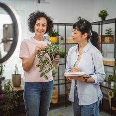 two woman use mobile phone for live stream about care home plants