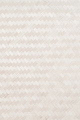 Fototapeta premium Light brown bamboo woven wall for abstract background and weave texture. beautiful patterns, space for work, banner, copy space, close up. Vertical.