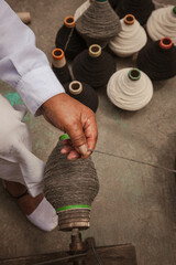 Indigenous artisans from Otavalo making a completely handmade wool poncho.