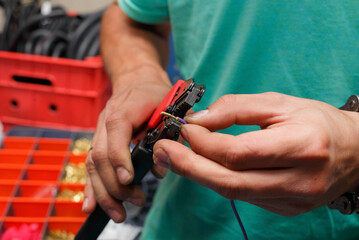 The wizard is preparing a new electrical wire to replace the damaged one on the motorcycle.