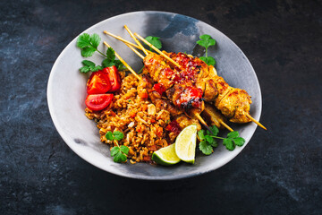 authentic Sate Ayam- Grilled chicken satay sate skewers with stir-fried rice and vegetable