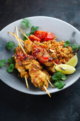 authentic Sate Ayam- Grilled chicken satay sate skewers with stir-fried rice and vegetable