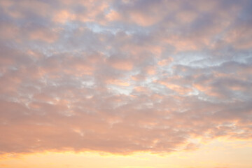 Obraz premium Beautiful sky with clumps of clouds at sunset, soft pink-orange colors. Heavenly landscape