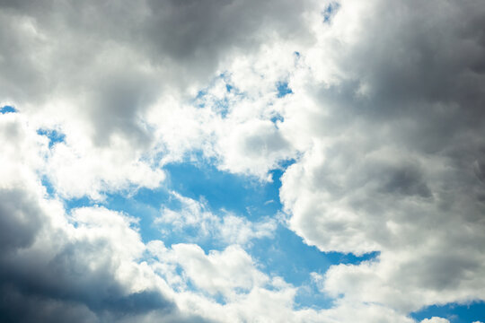 Dramatic sky. Dark cloudy sky with a light interval of clear blue sky - Powered by Adobe