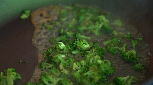 Fried broccoli on a frying pan.
Water evaporates from a hot frying pan.
Boiling water and green broccoli.
Fried broccoli.
Healthy cooking