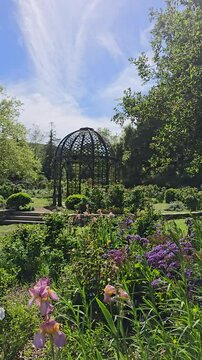 footage of a gorgeous spring landscape with a gazebo, lush green trees and colorful flowers at Descanso Gardens La Ca&ntilde;ada Flintridge California USA