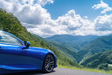 Blue car on scenic mountain road under a vibrant sky