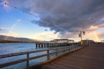 sunset on the pier with a rainbow