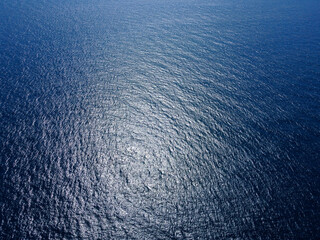 Sea surface, aerial drone view. Flight above the surface of the deep blue sea.
